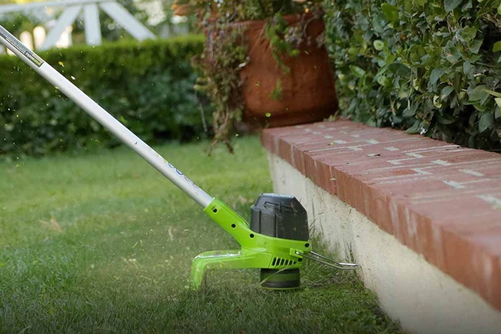 String Trimmer and Edger cutting grass