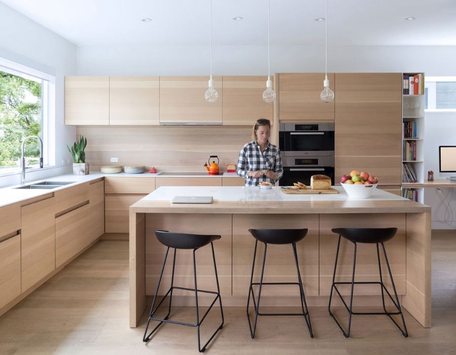 woman in a kitchen preparing a sandwich 