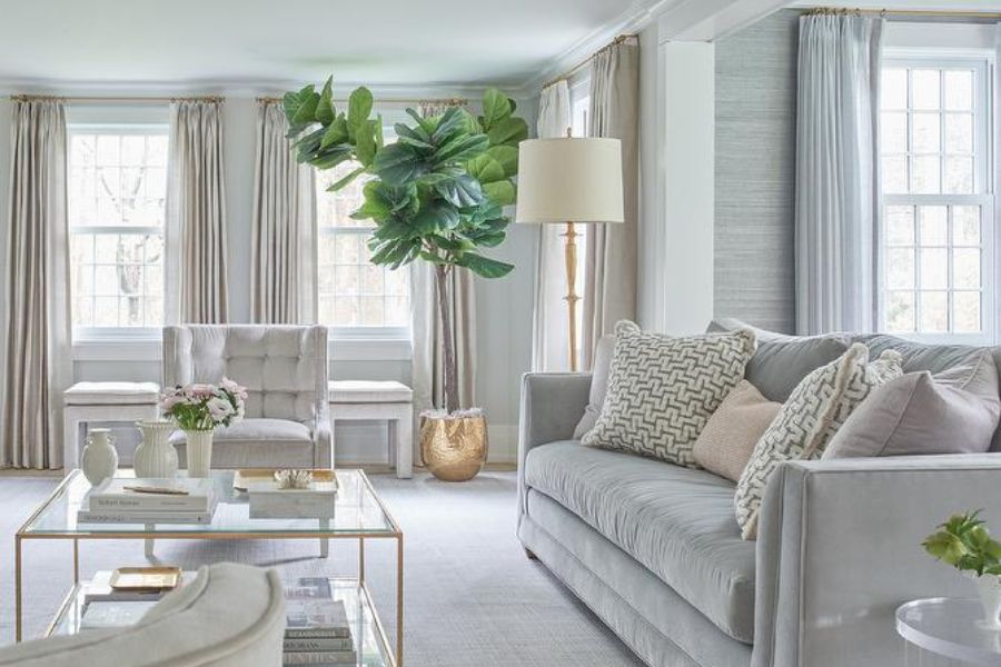 light gray velvet sofa in light gray-walled living space