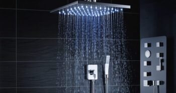A modern bathroom highlighting a deluxe triple shower head system with an overhead rainfall shower head, a handheld sprayer, and a body jet, set amidst ambient lighting for a spa-like experience.