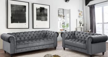 light gray wall with dark gray tufted furniture